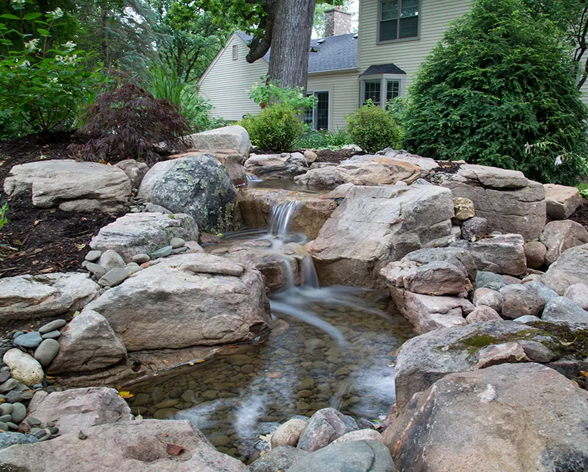 Pondless waterfall in a landscaped yard
