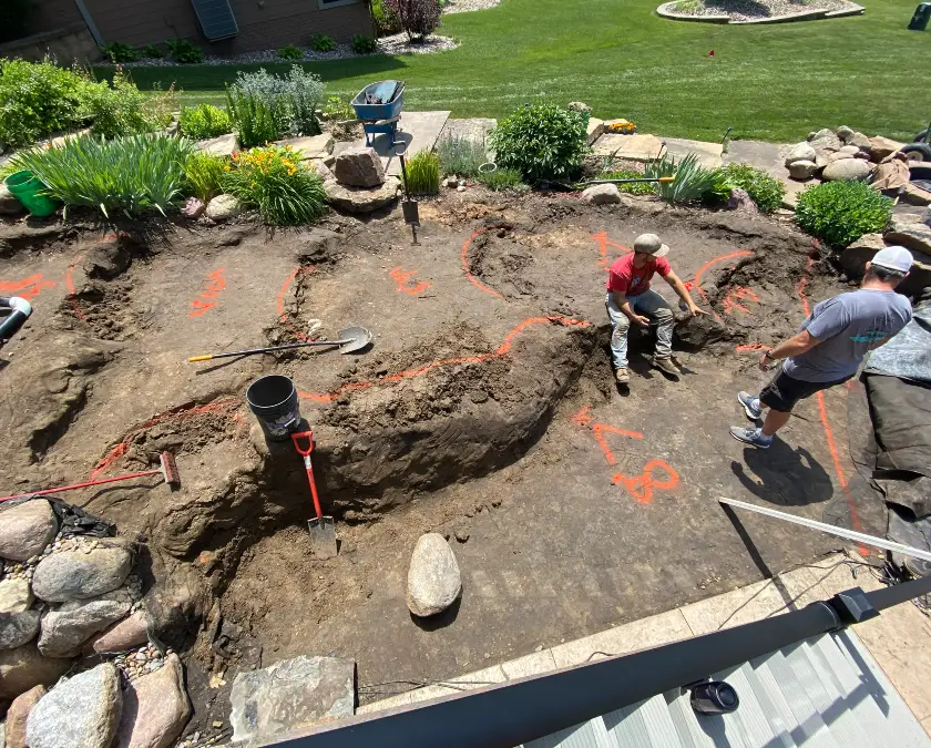 Just Add Water crew excavating and shaping a new pond on a marked-out site
